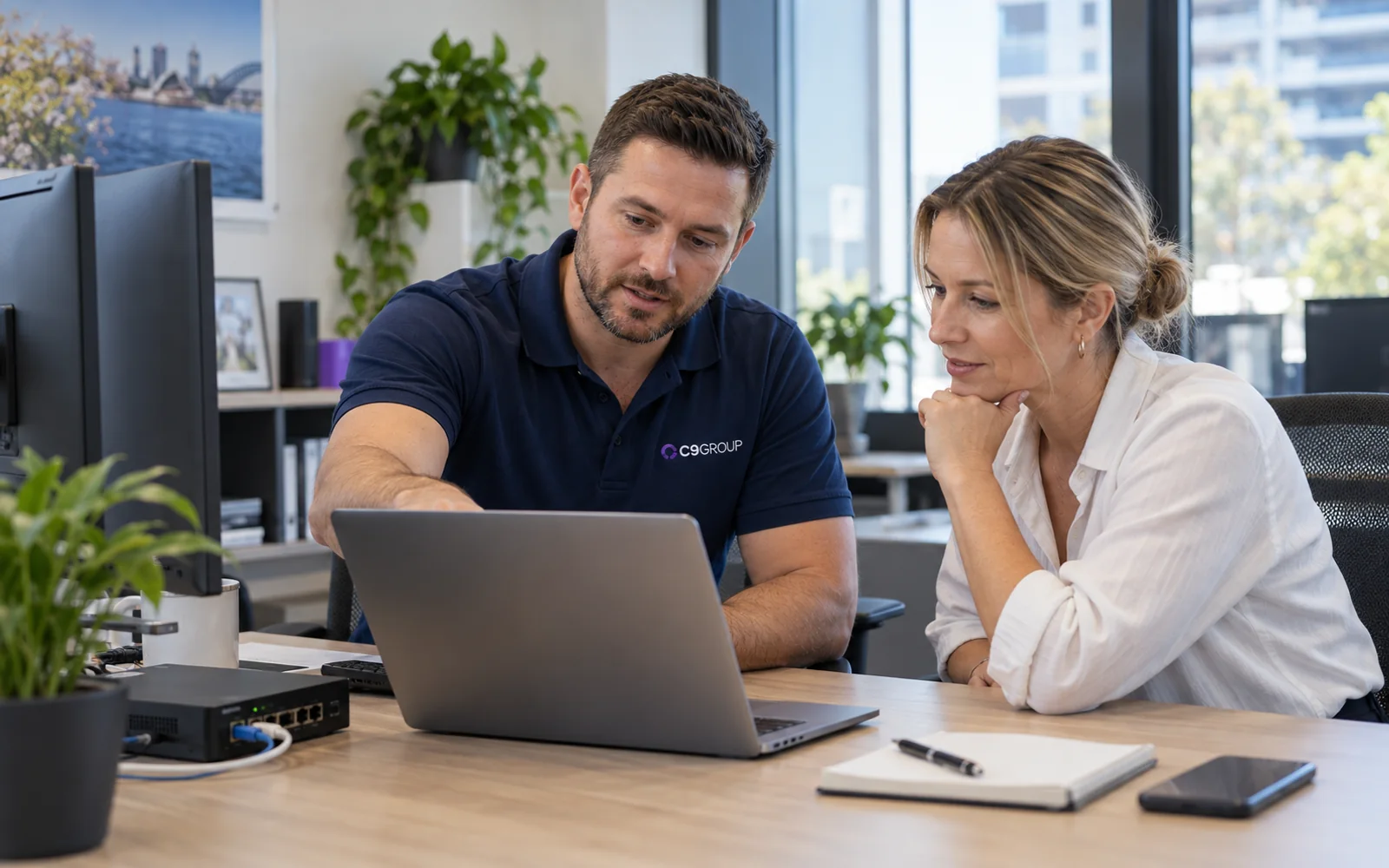C9 GROUP managed IT specialist helping a business owner resolve network issues